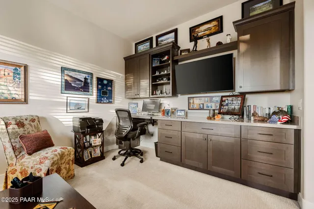 a living room with furniture and a painting on the wall