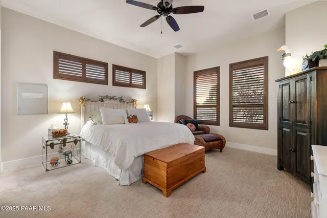 a view of a hallway with wooden floor and windows
