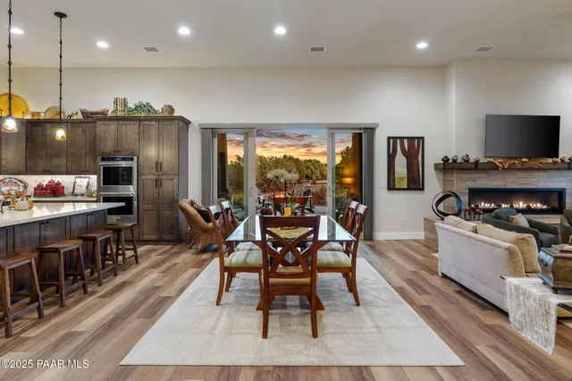 a kitchen with stainless steel appliances granite countertop a sink a stove and a refrigerator