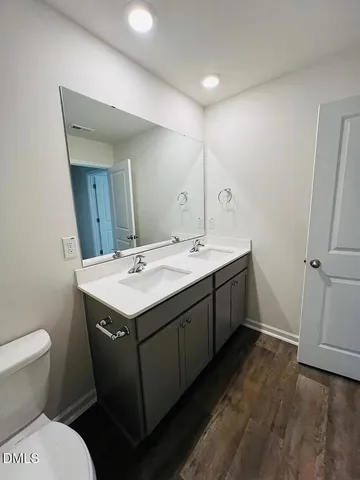 a bathroom with a double vanity sink and mirror