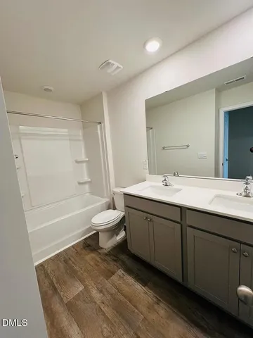 a bathroom with a tub sink and a mirror
