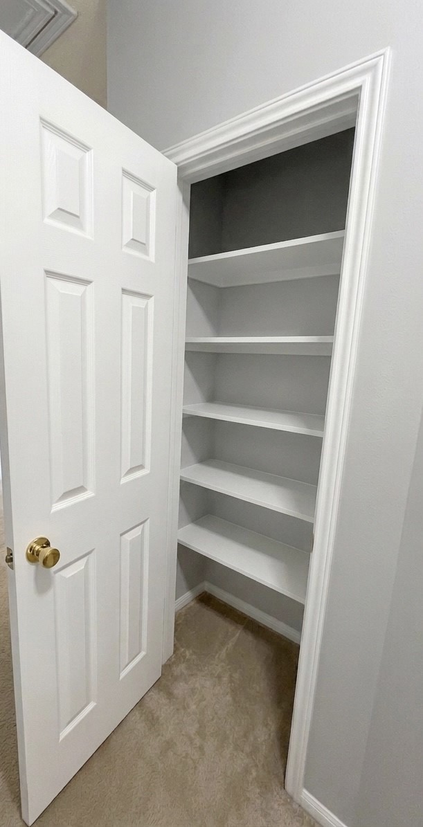 9908 Climbing Tree Street Conroe, TX 77385 - Photo 19 of 26 a view of walk in closet with empty racks