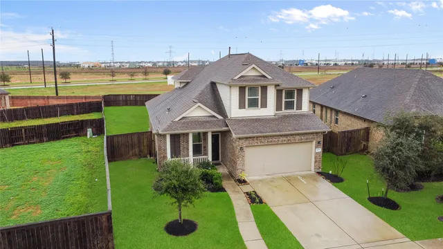 a aerial view of a house with a yard and balcony