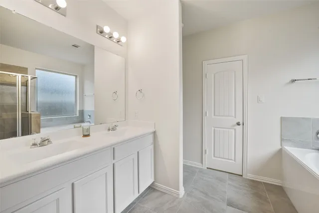 a bathroom with a double vanity sink and mirror