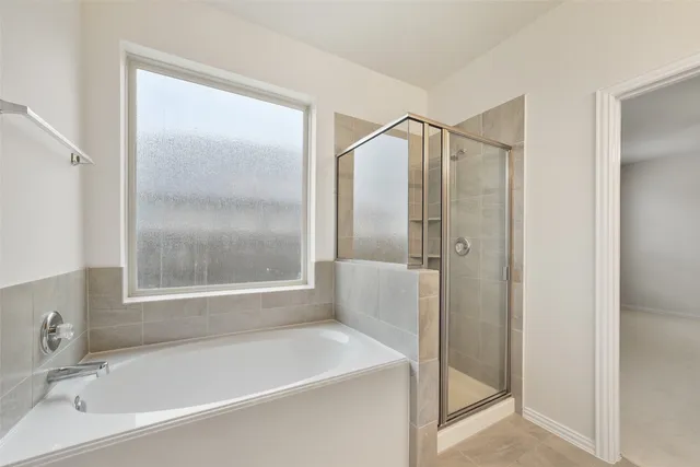 a bathroom with a tub and a shower