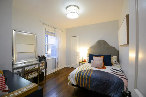 a bedroom with a bed and wooden floor