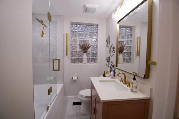 a bathroom with a sink toilet and shower