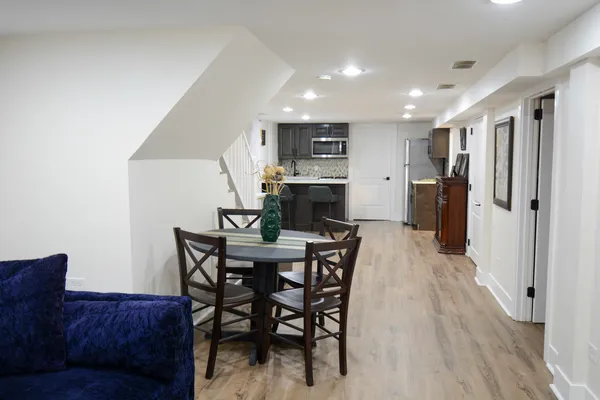 a view of a dining room with furniture and wooden floor