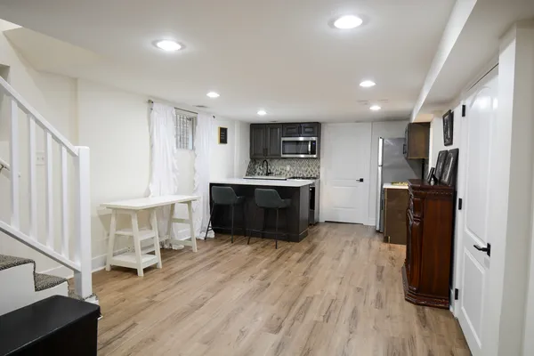 a kitchen with a refrigerator and a stove top oven