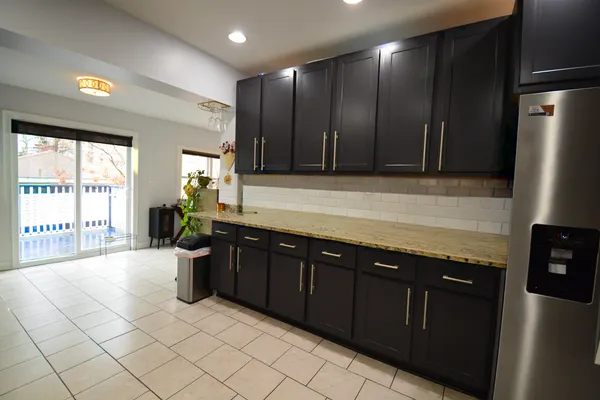 a kitchen with stainless steel appliances granite countertop a refrigerator and a sink