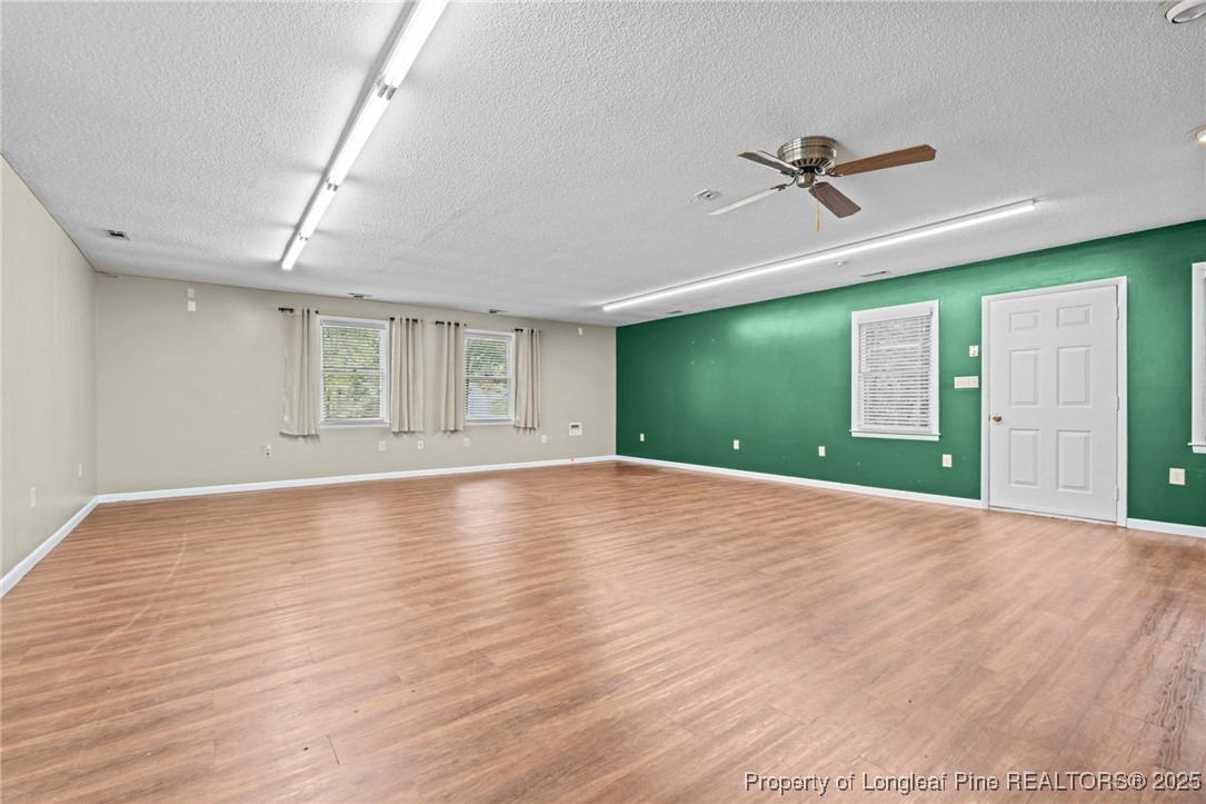610 Maynard Lake Road Erwin, NC 28339 - Photo 33 of 49 a view of empty room with wooden floor and fan