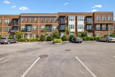 a front view of a residential apartment building with a yard