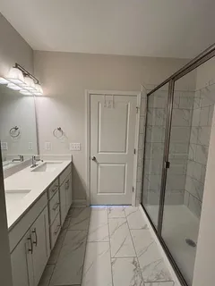a bathroom with a sink a mirror and a shower
