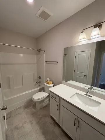 a bathroom with a double vanity sink toilet and shower