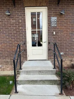 a front view of a house with a window and brick walls