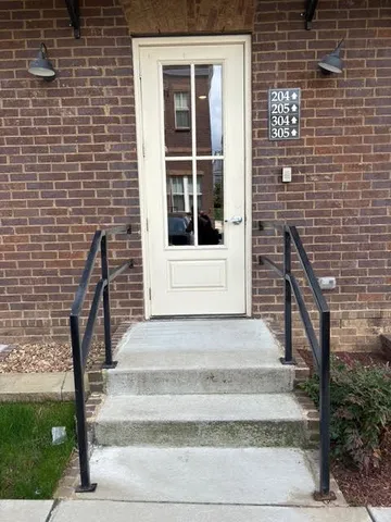 a front view of a house with a window and brick walls
