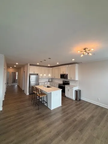 a kitchen with a sink cabinets and wooden floor