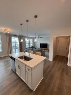 a kitchen with stainless steel appliances granite countertop a sink and a stove