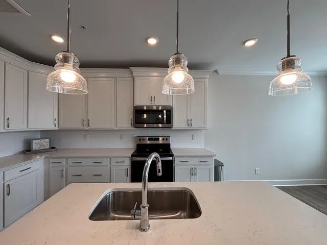a kitchen with a sink a counter space and cabinets