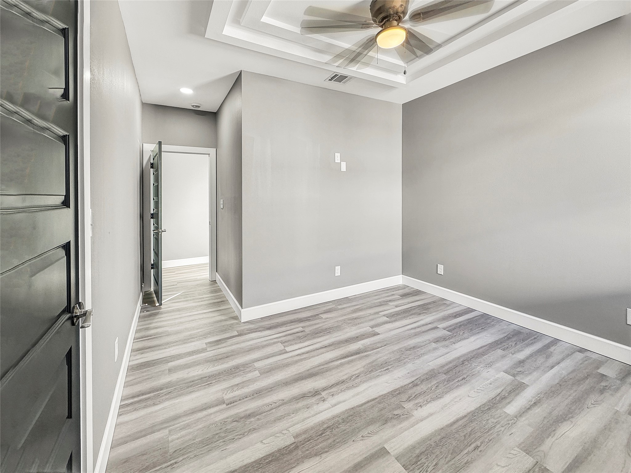 4817 Los Angeles Street Houston, TX 77026 - Photo 13 of 20 a view of a livingroom with wooden floor and a ceiling fan