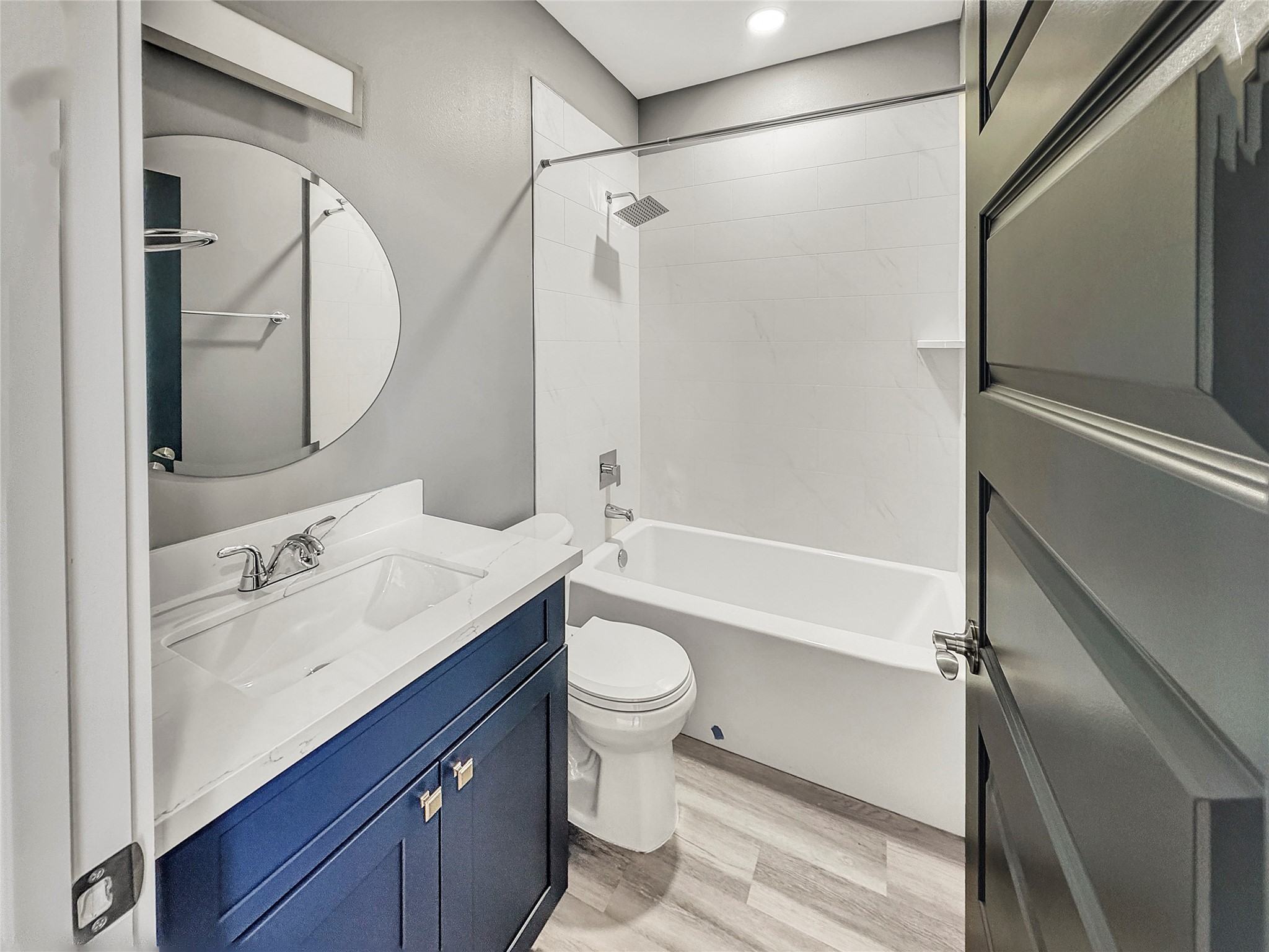 4817 Los Angeles Street Houston, TX 77026 - Photo 15 of 20 a bathroom with a sink a toilet and a mirror