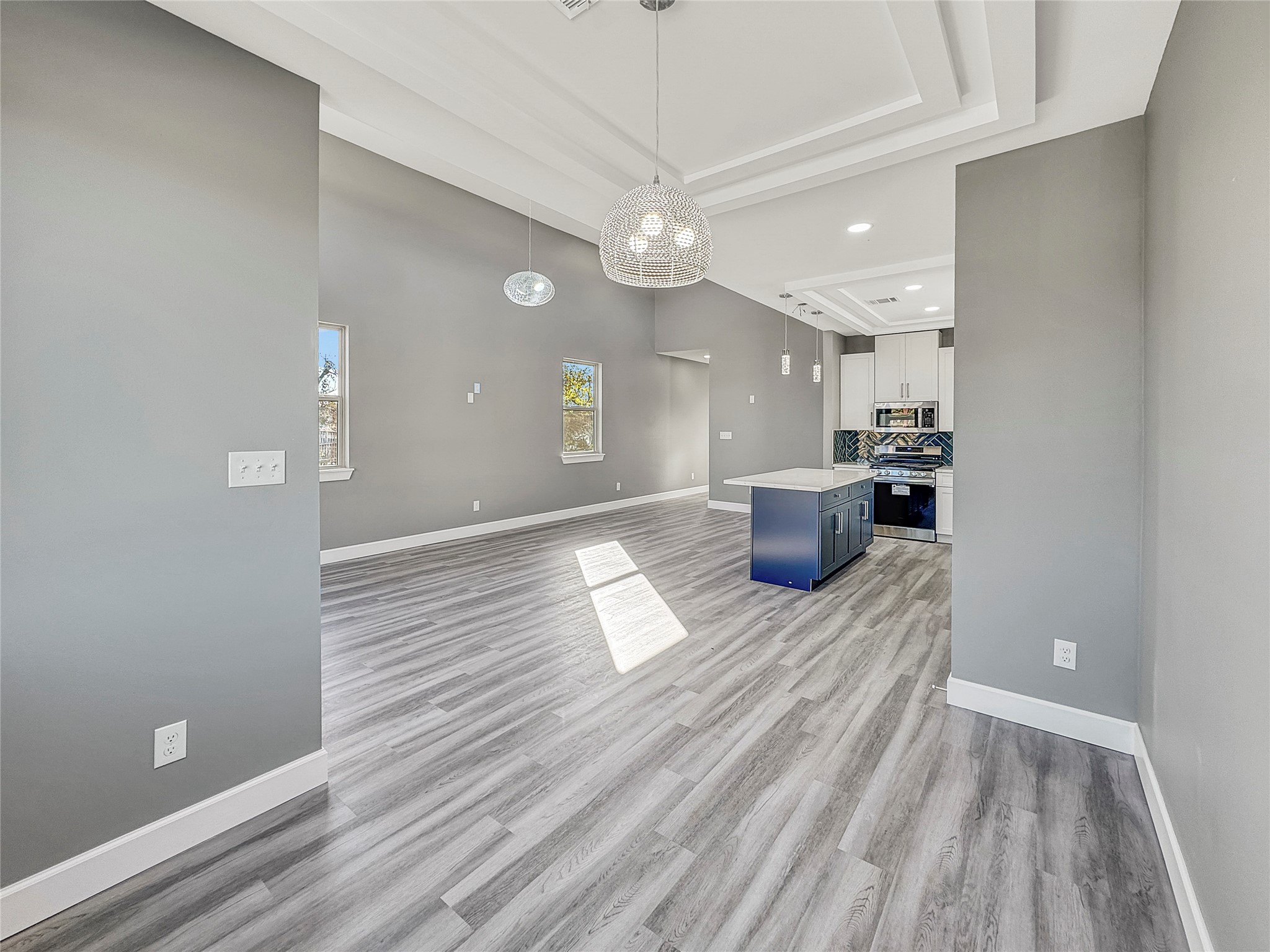 4817 Los Angeles Street Houston, TX 77026 - Photo 8 of 20 a view of a living room and kitchen with furniture wooden floor and windows