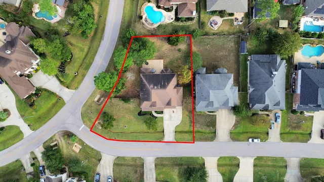 an aerial view of residential houses with outdoor space and street view