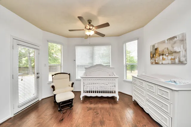 a bedroom with a bed and a large window