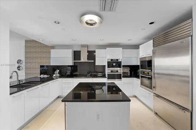 a kitchen with a sink a stove and refrigerator