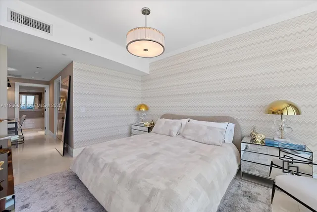 a bedroom with a bed and a chandelier