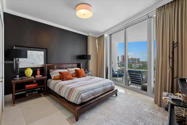 a bedroom with a bed and a flat tv screen on dresser