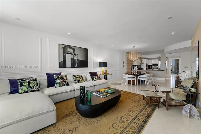 a living room with furniture and view of kitchen
