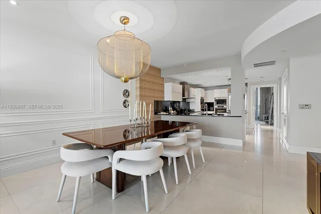 a dining room with furniture and a chandelier