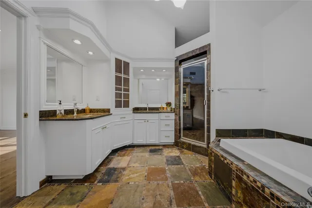 a kitchen with a refrigerator and white cabinets