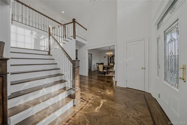 a view of entryway and hall with wooden floor