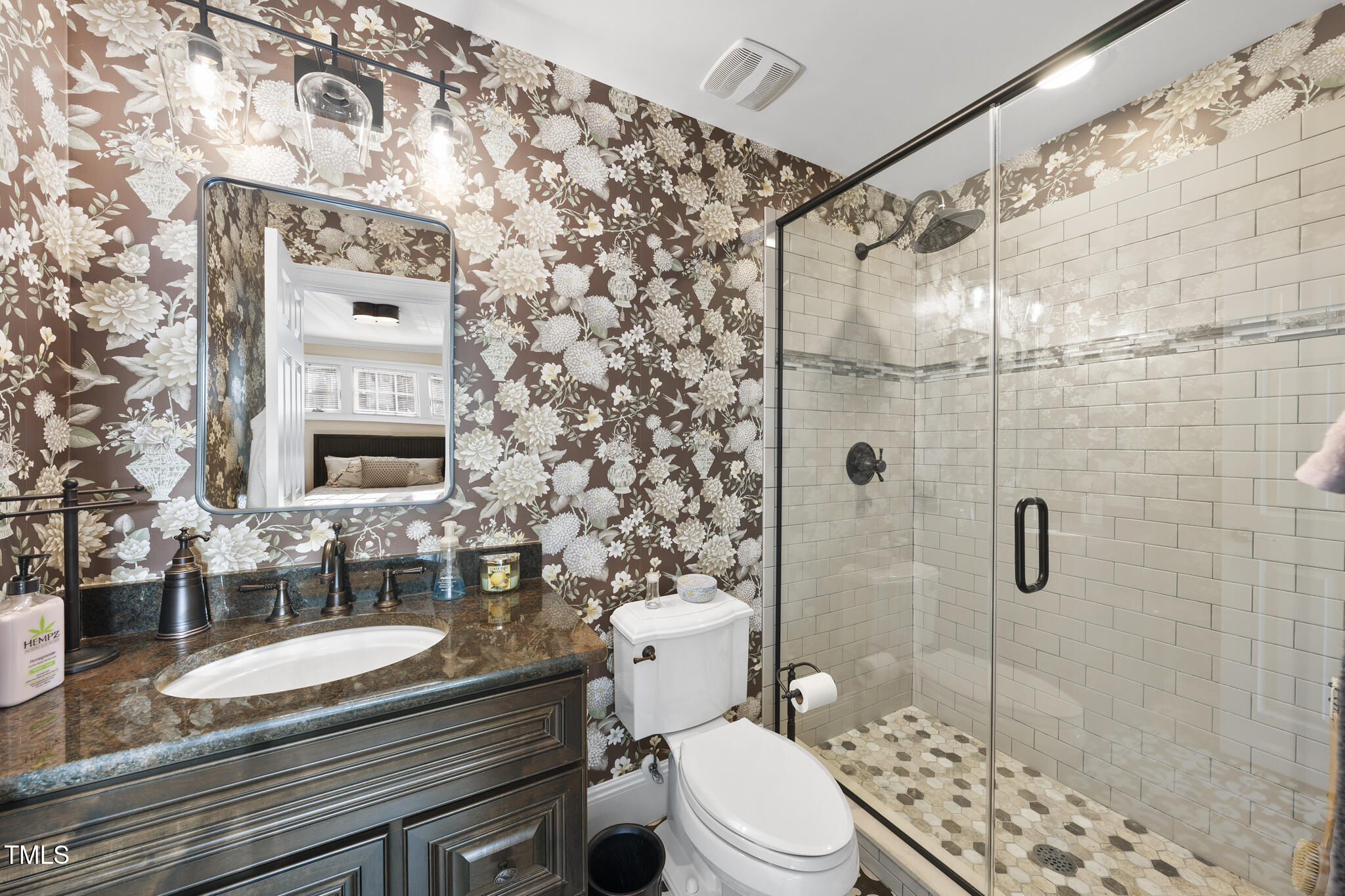920 West Johnson Street Raleigh, NC 27605 - Photo 10 of 42 a bathroom with a granite countertop toilet a sink a mirror and shower