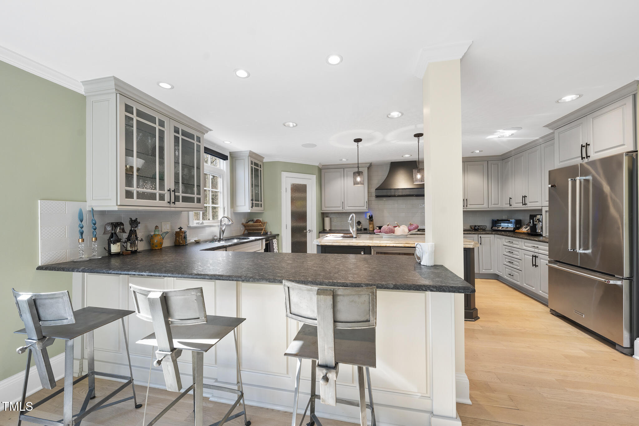 920 West Johnson Street Raleigh, NC 27605 - Photo 14 of 42 a kitchen with stainless steel appliances granite countertop a stove top oven a sink a refrigerator and chairs