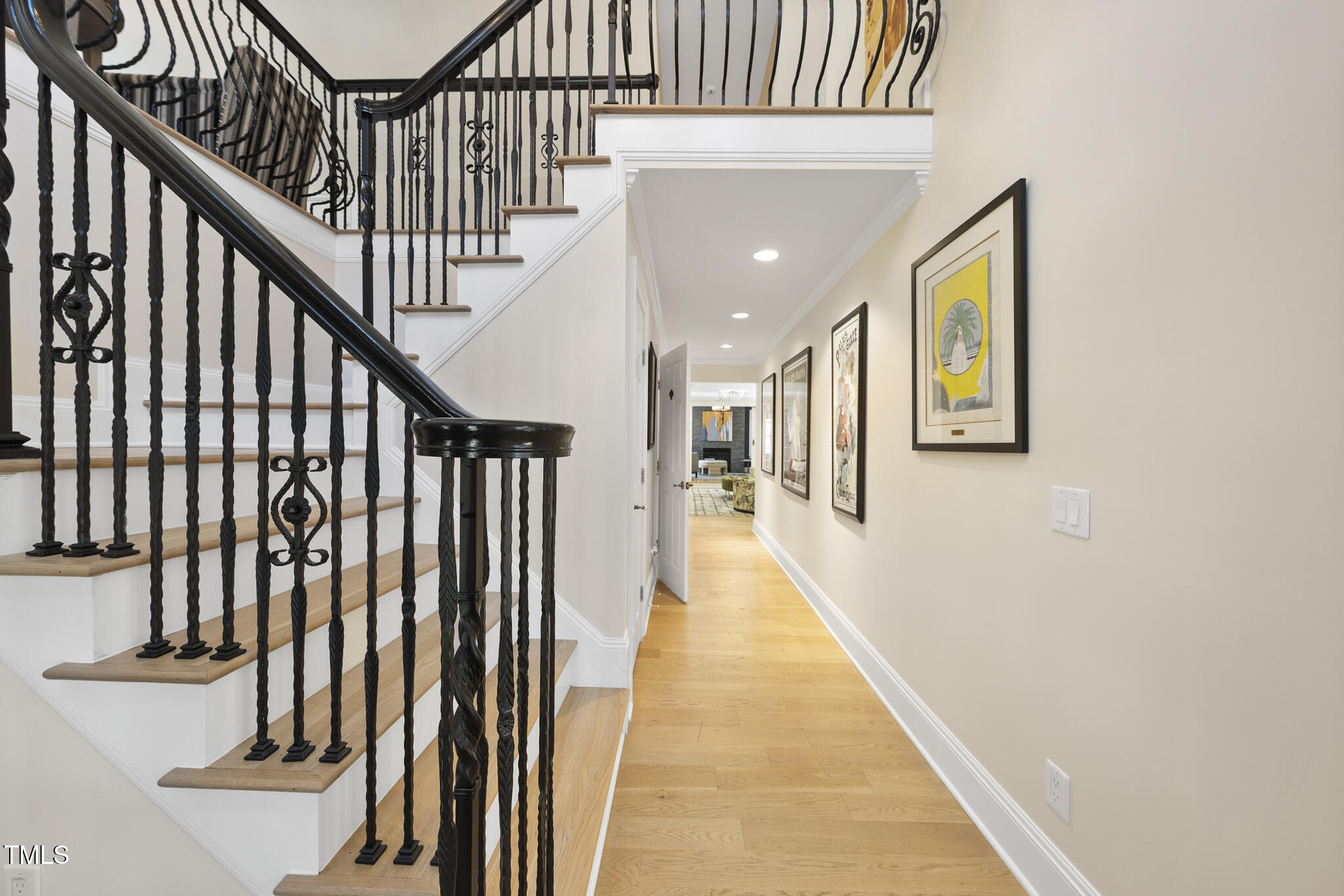 920 West Johnson Street Raleigh, NC 27605 - Photo 8 of 42 a view of staircase with lots of frames on wall and wooden floor