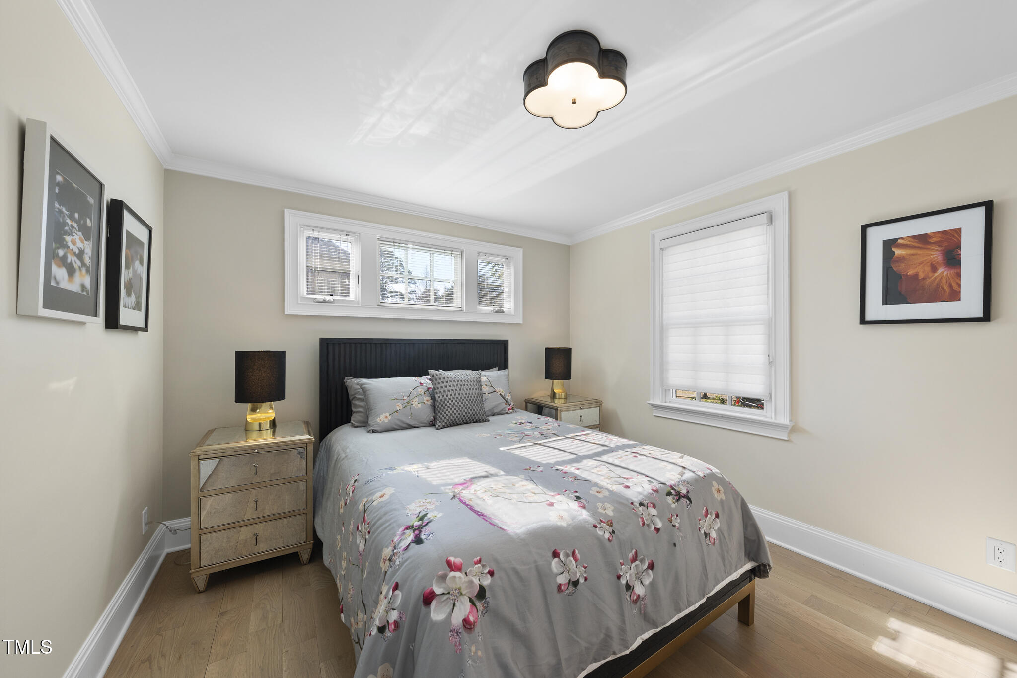 920 West Johnson Street Raleigh, NC 27605 - Photo 9 of 42 a bedroom with a bed and a chandelier