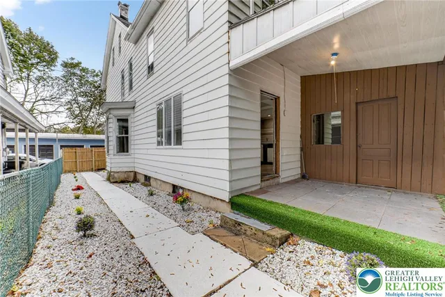 a front view of a house with a yard and seating space