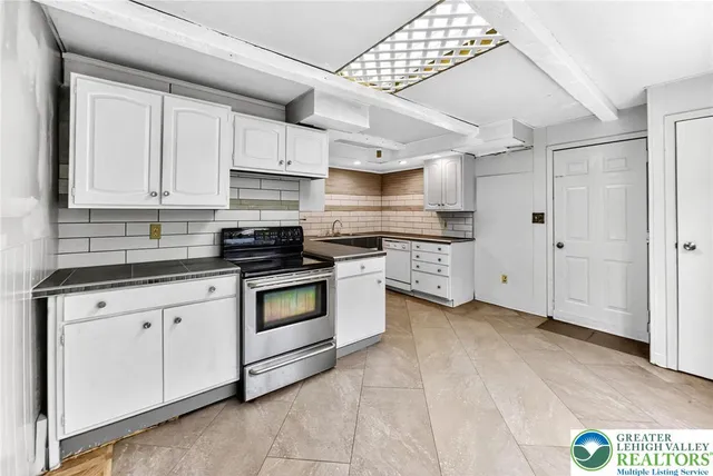 a kitchen with stainless steel appliances granite countertop a stove and a sink