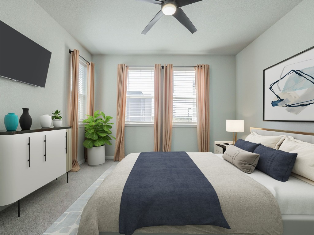 9015 Cattle Baron Path, Unit 502 Austin, TX 78747 - Photo 11 of 40 a bedroom with a large bed and tv