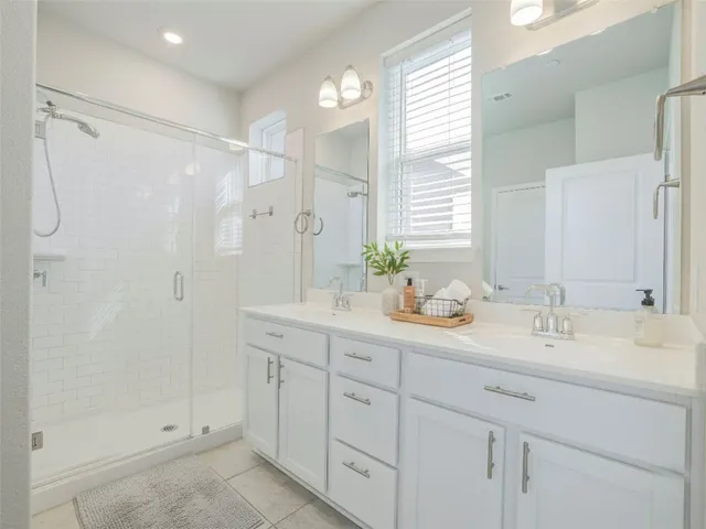 a spacious bathroom with a shower and a sink
