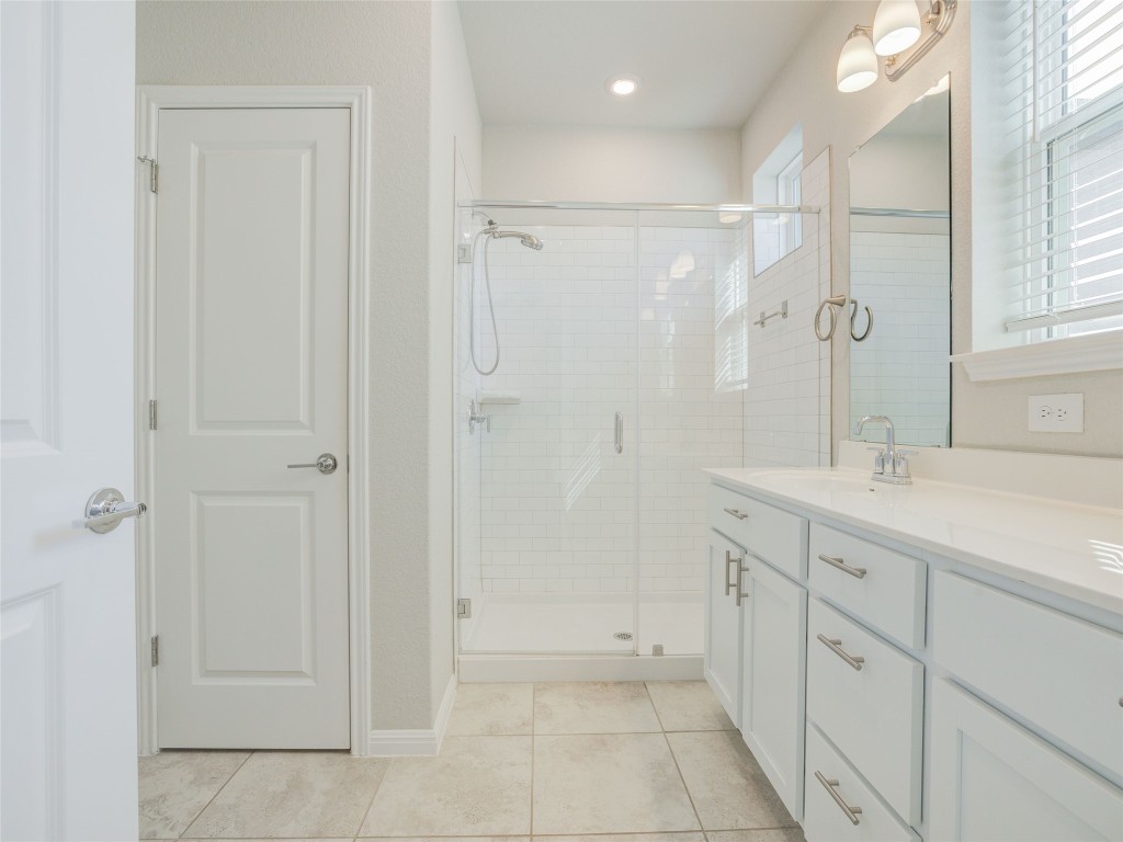 9015 Cattle Baron Path, Unit 502 Austin, TX 78747 - Photo 16 of 40 a spacious bathroom with a shower and a sink