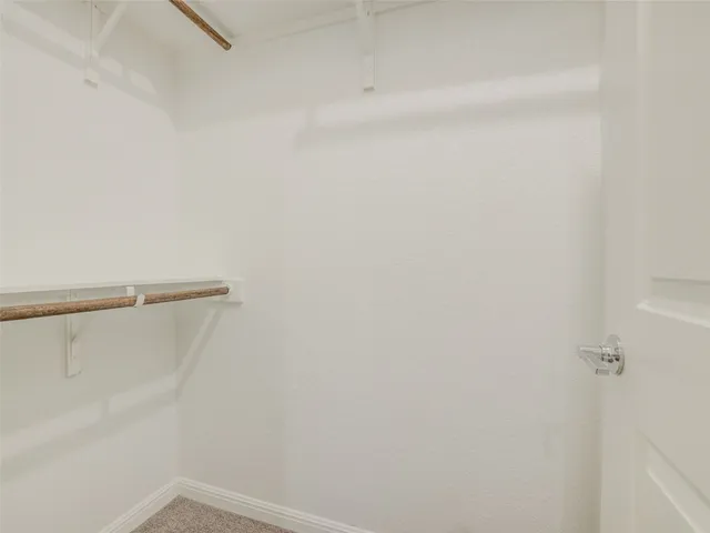a view of an empty room and a ceiling fan window