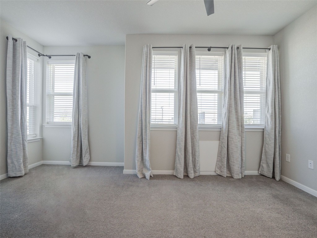 9015 Cattle Baron Path, Unit 502 Austin, TX 78747 - Photo 22 of 40 Unfurnished room featuring light colored carpet and a ceiling fan