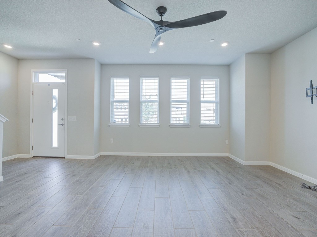 9015 Cattle Baron Path, Unit 502 Austin, TX 78747 - Photo 28 of 40 an empty room with wooden floor and windows