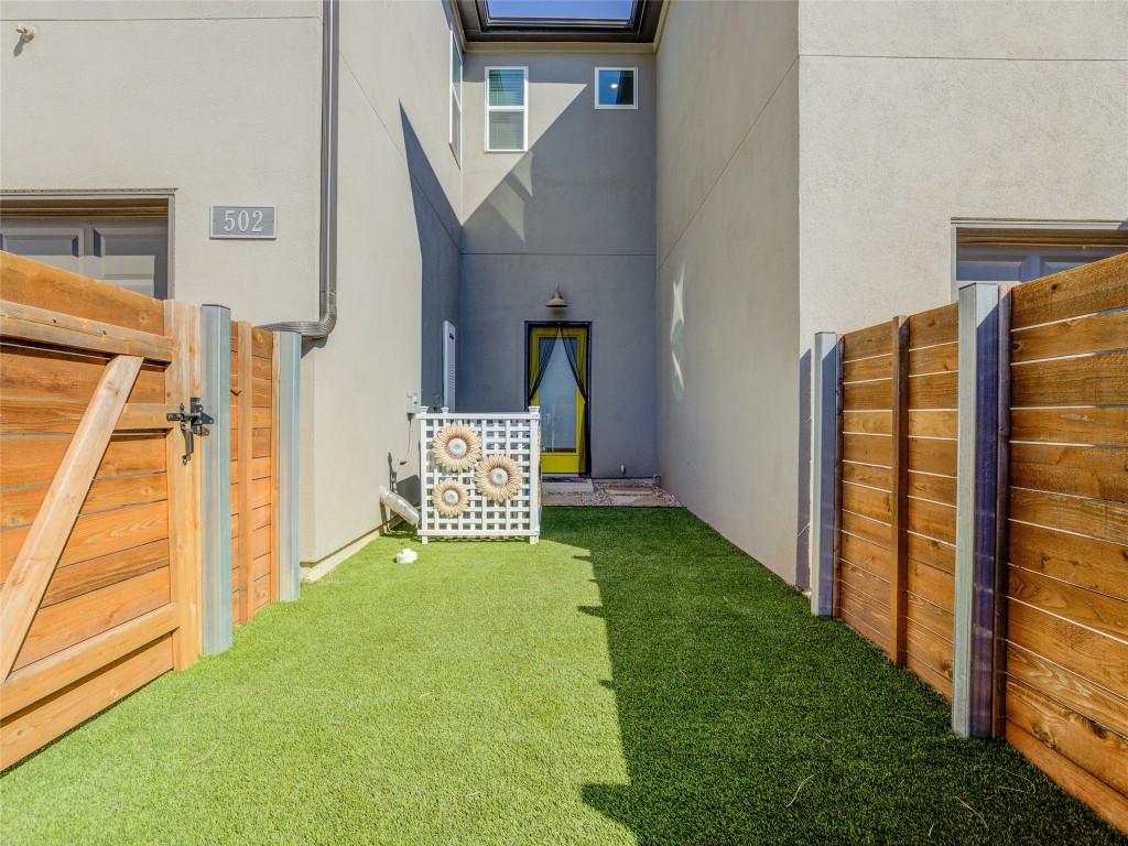 9015 Cattle Baron Path, Unit 502 Austin, TX 78747 - Photo 35 of 40 View of yard featuring a gate