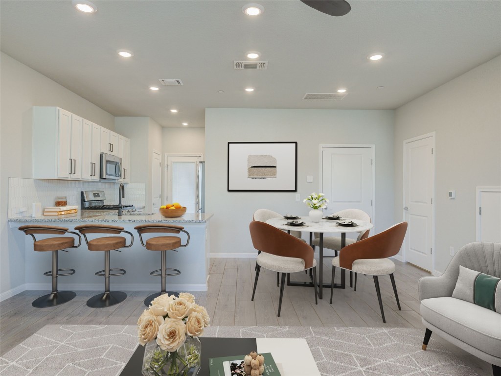 9015 Cattle Baron Path, Unit 502 Austin, TX 78747 - Photo 4 of 40 a living room with furniture a rug and a table