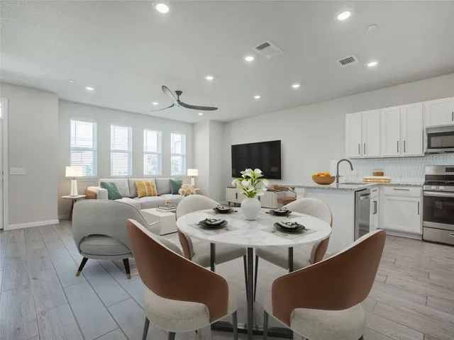a view of a dining room with furniture and wooden floor